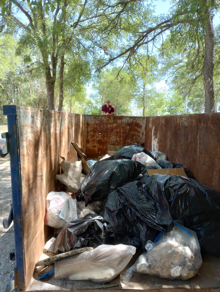 Bags of trash in a dumpster